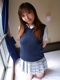 Haruka Ohsawa posing in her schoolgirl uniform and hiking up her top to show her big boobs